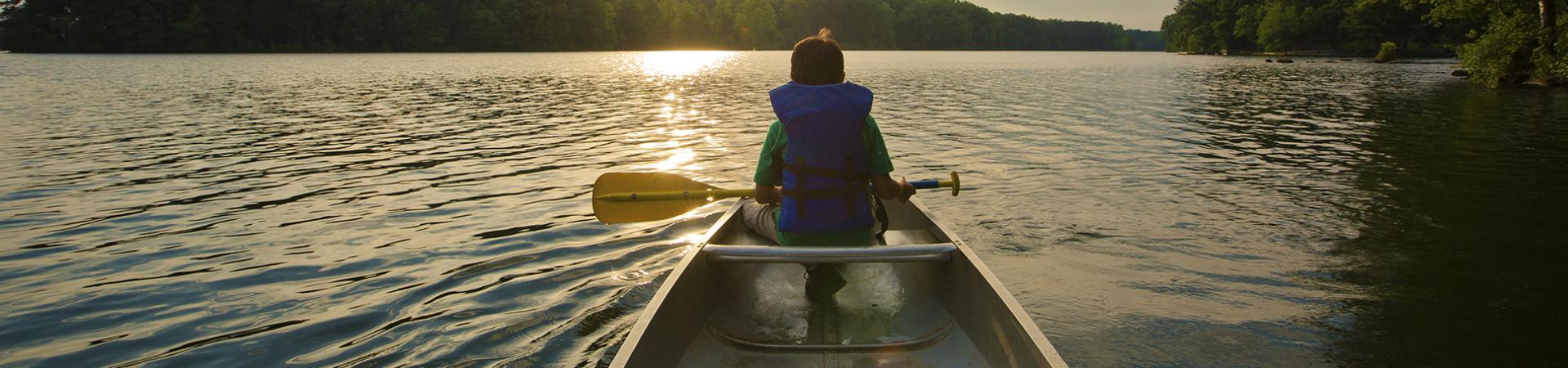 Man on kayak going down a river